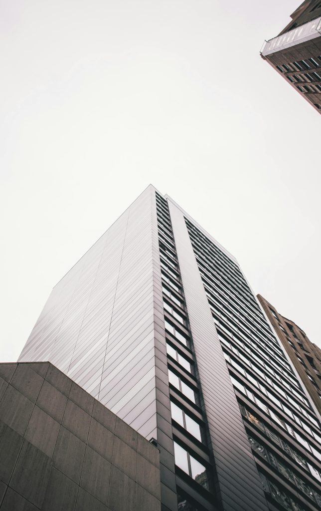 A striking low angle shot of a modern skyscraper in downtown Chicago, accentuating its vertical lines.