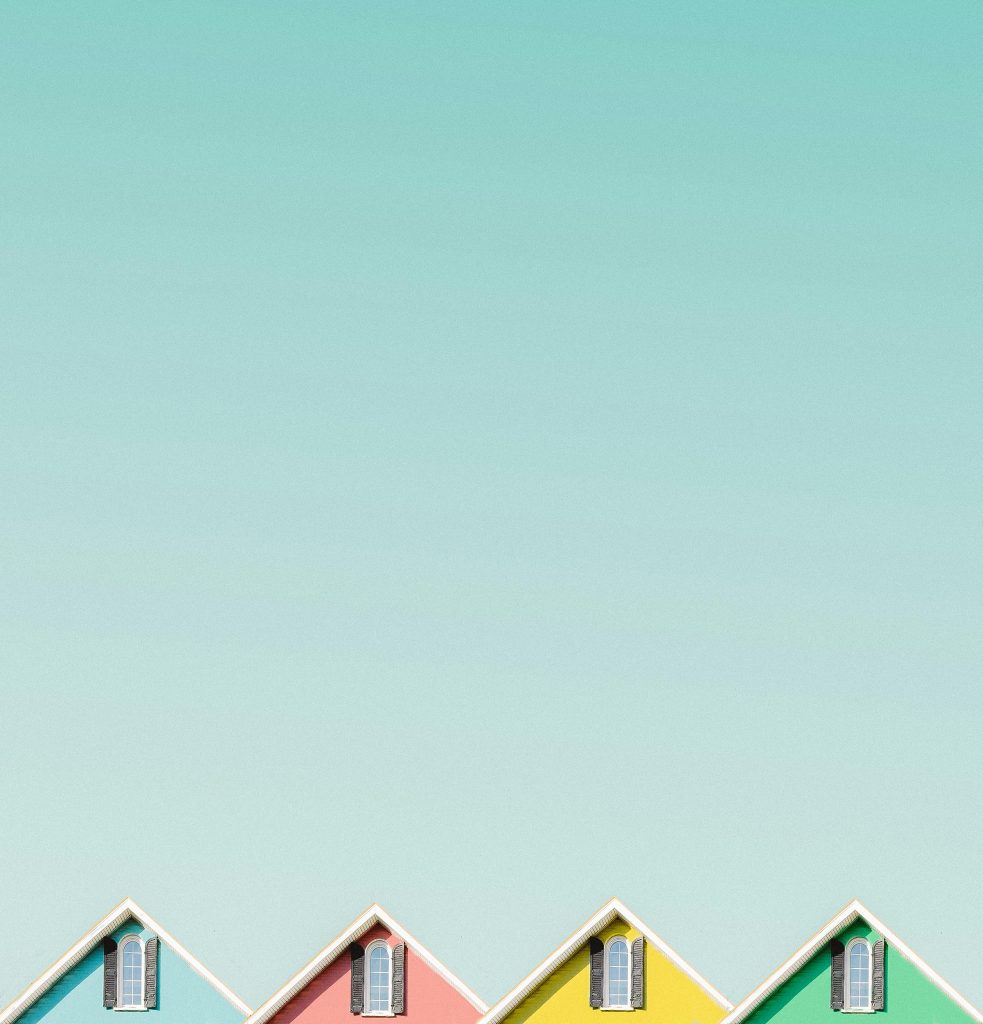 Aesthetic view of vibrant house roofs under a clear turquoise sky in Buffalo, NY.